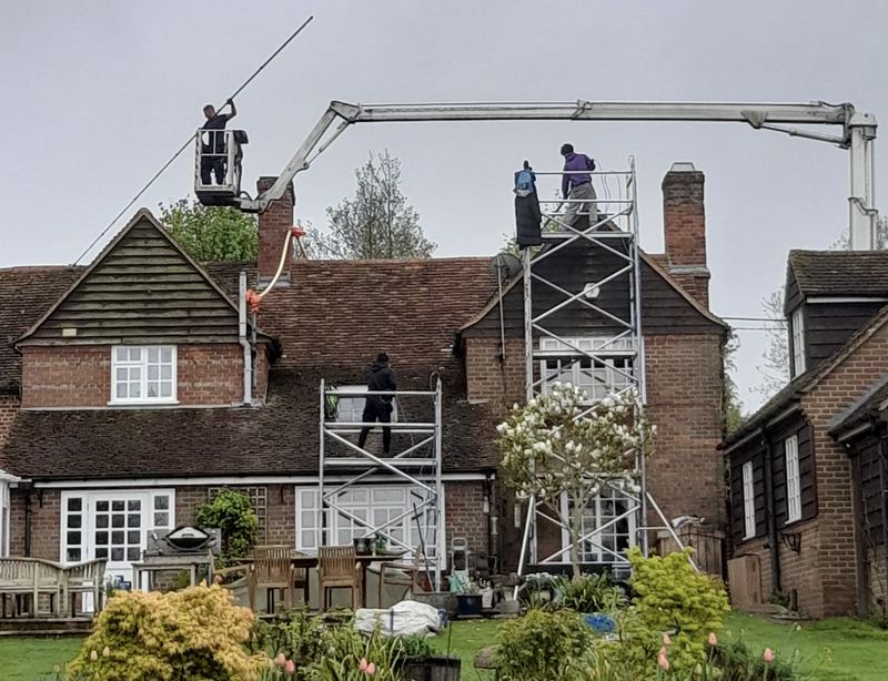 The Roof Moss Cleaners using cherry picker and scaffolding to clean roof safely and professionally in Sawston, Cambridgeshire
